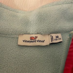 This is a Vineyard Vines Zip up sweatshirt and is a light teal and hot pink!